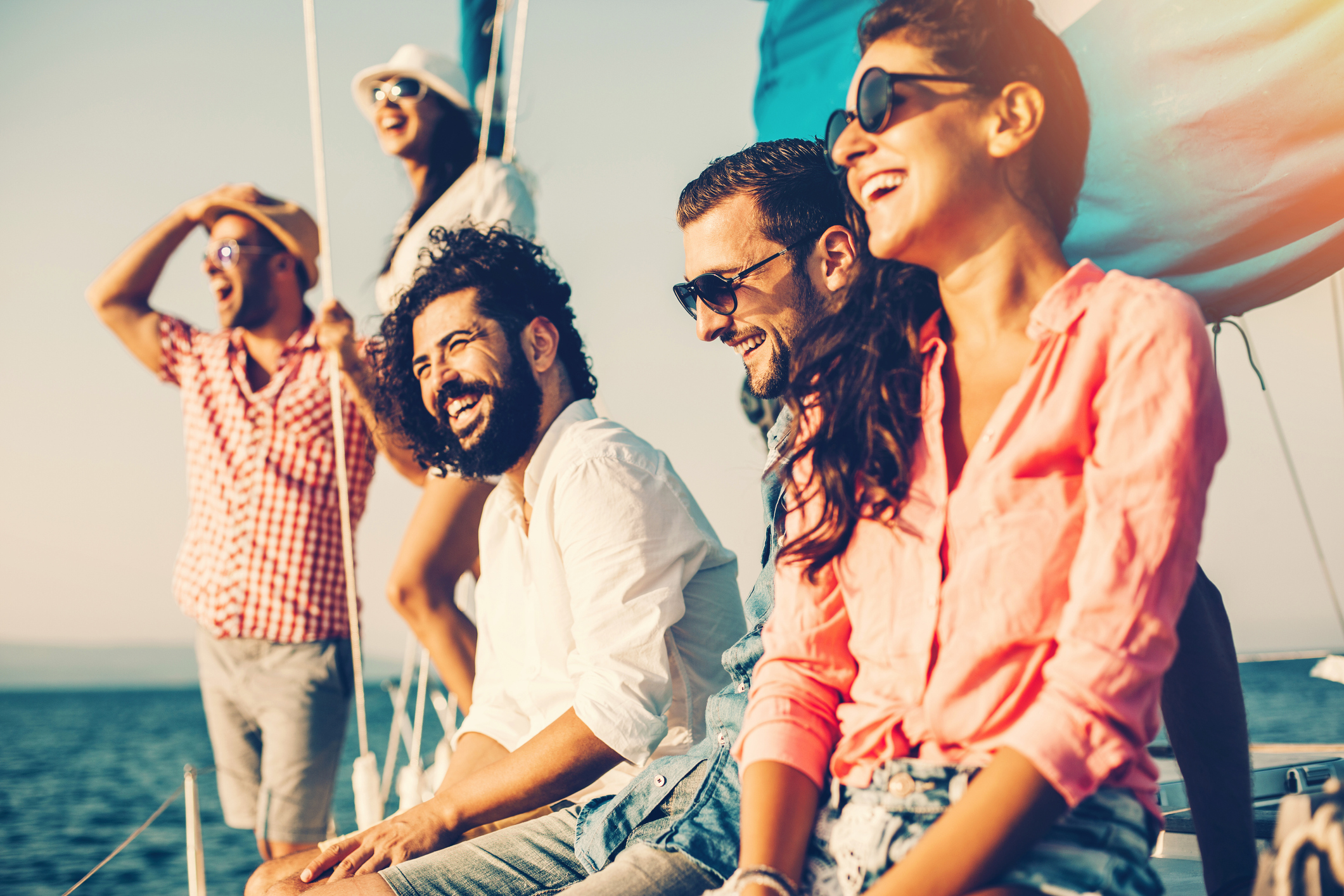 group of friends on board a yacht laughing