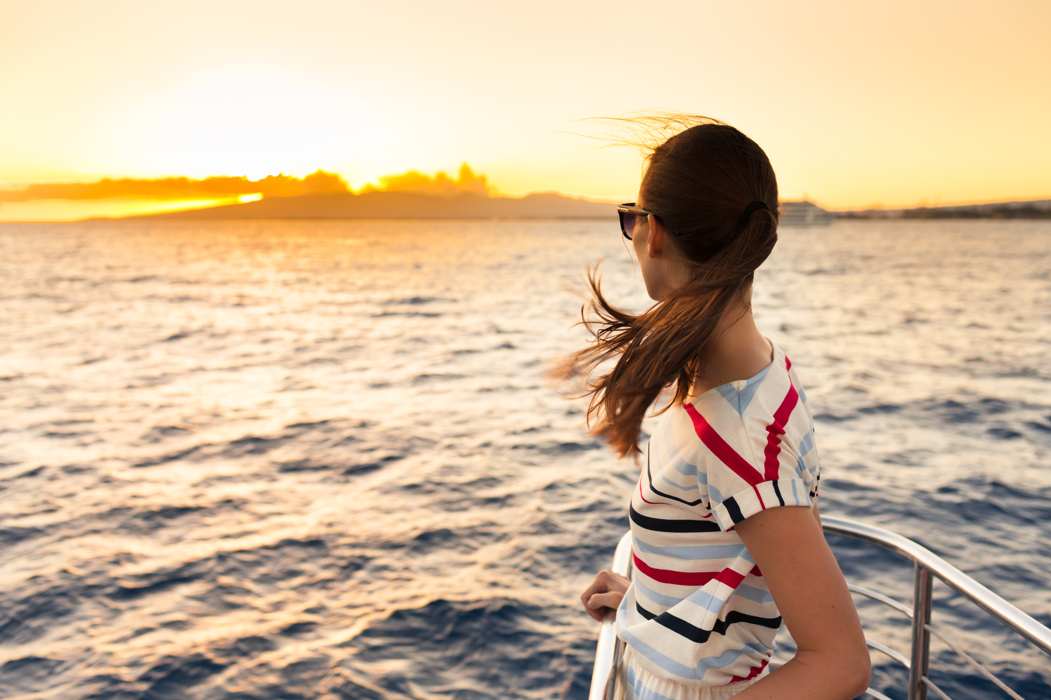 Woman looking out over water from boat