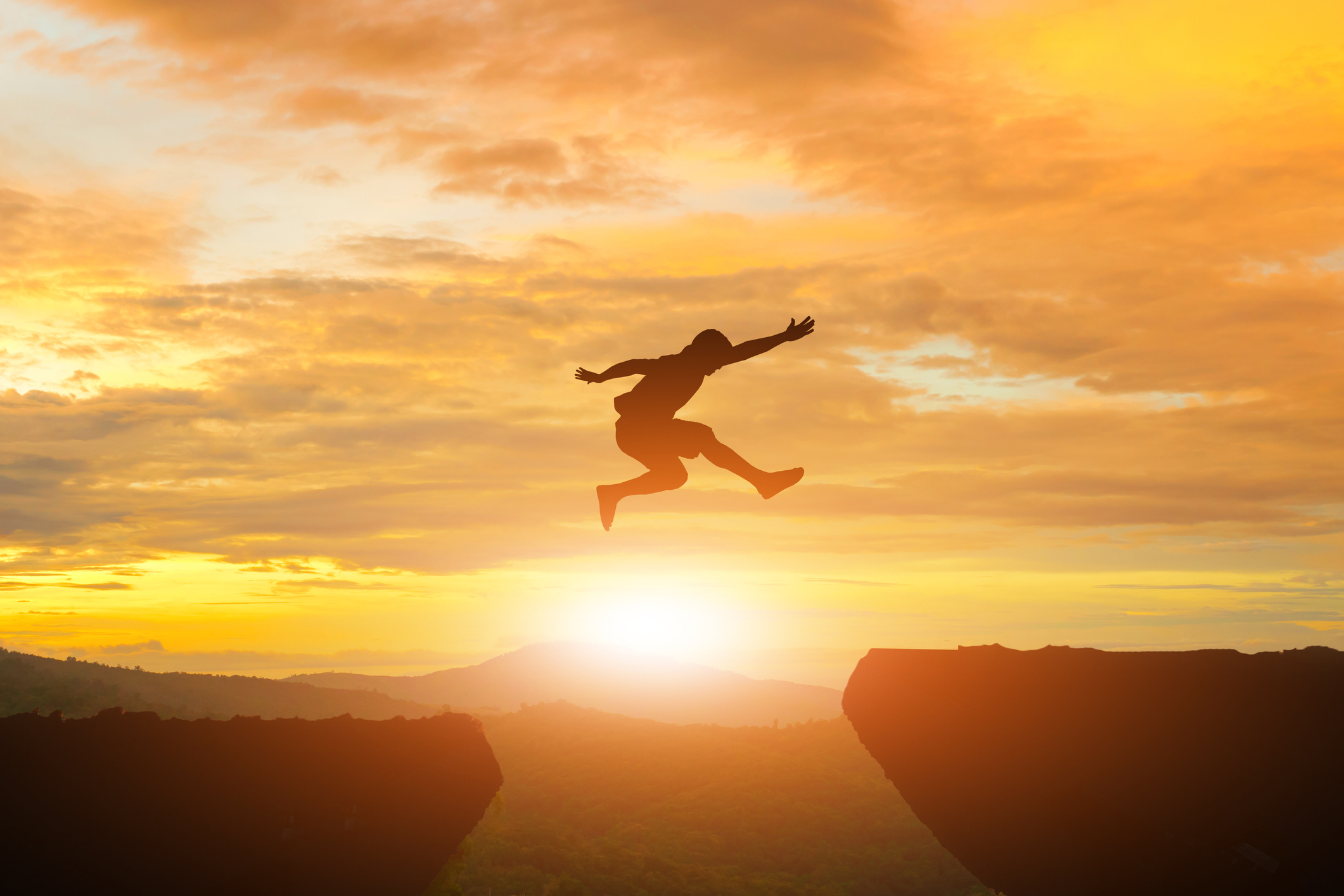 Person leaping from one cliff to the next