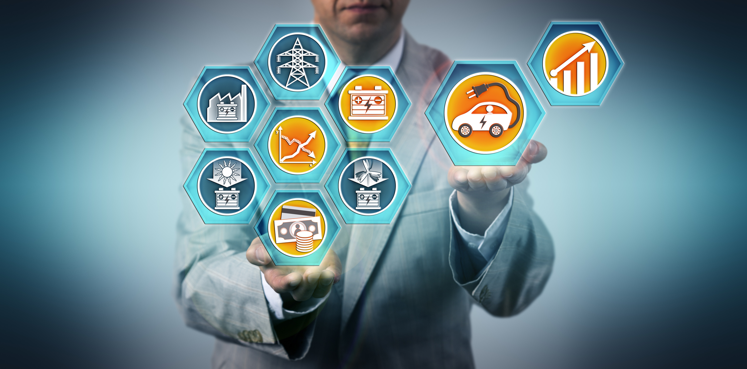 A person in a suit holding several renewable energy icons.