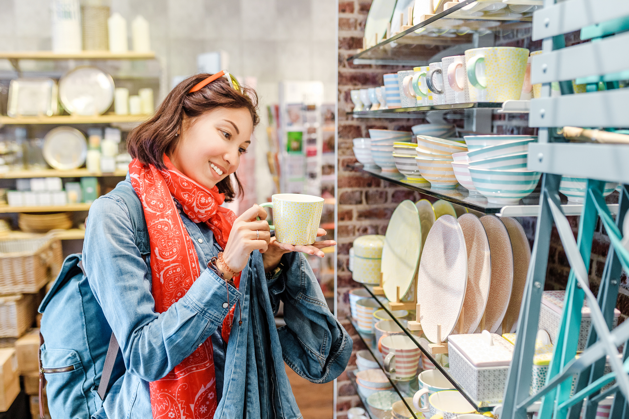 Woman looking at kitchenware in a home goods store