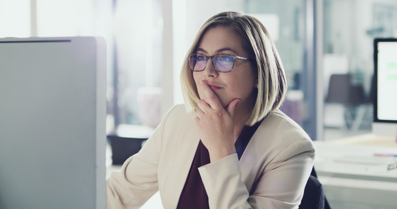 Smiling woman looking at computer screen
