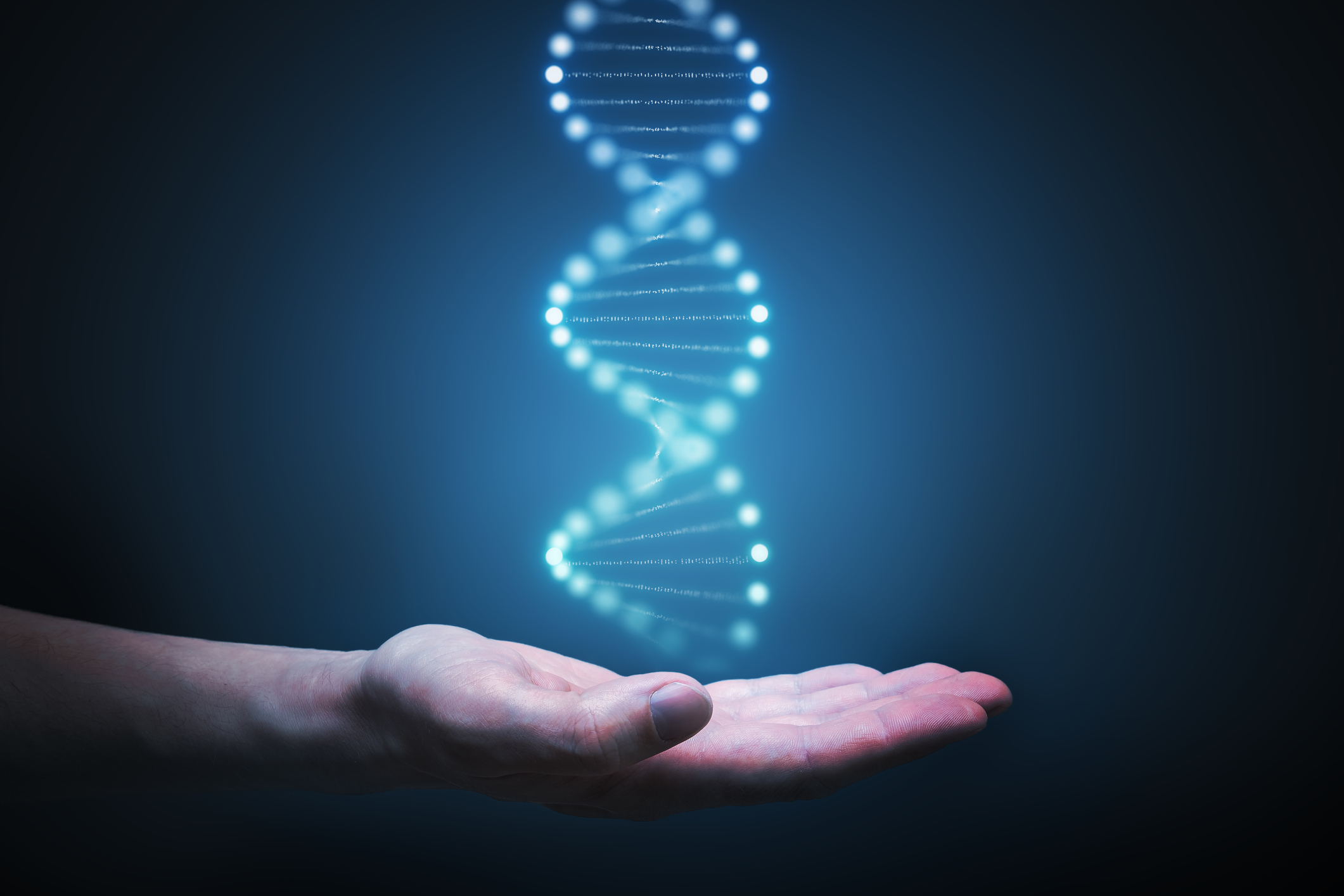Glowing DNA helix over an outstretched palm. 