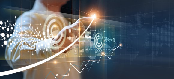 Someone drawing upward arrow over charts and targets