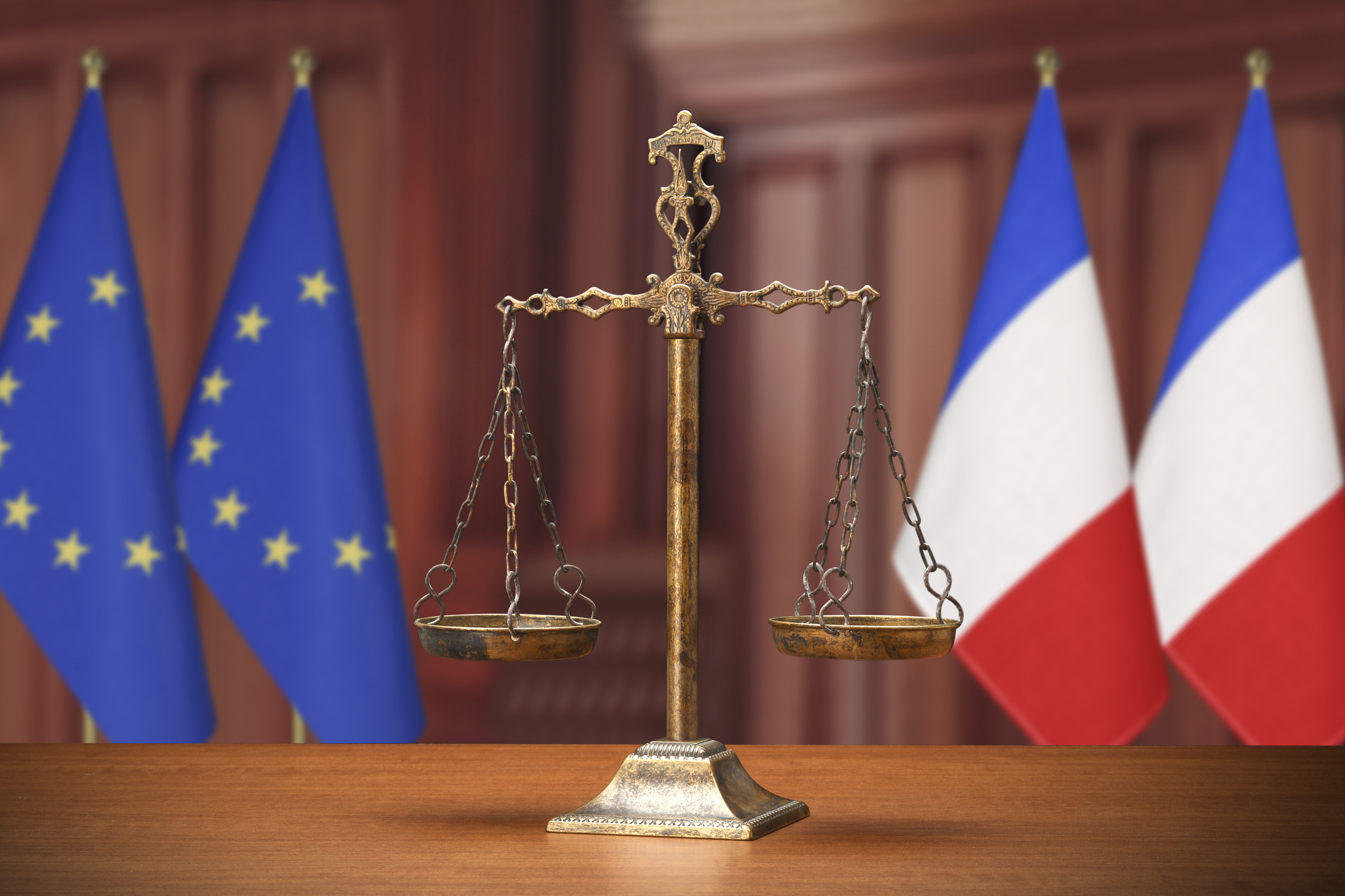 Scales of justice with EU and French flags in the background