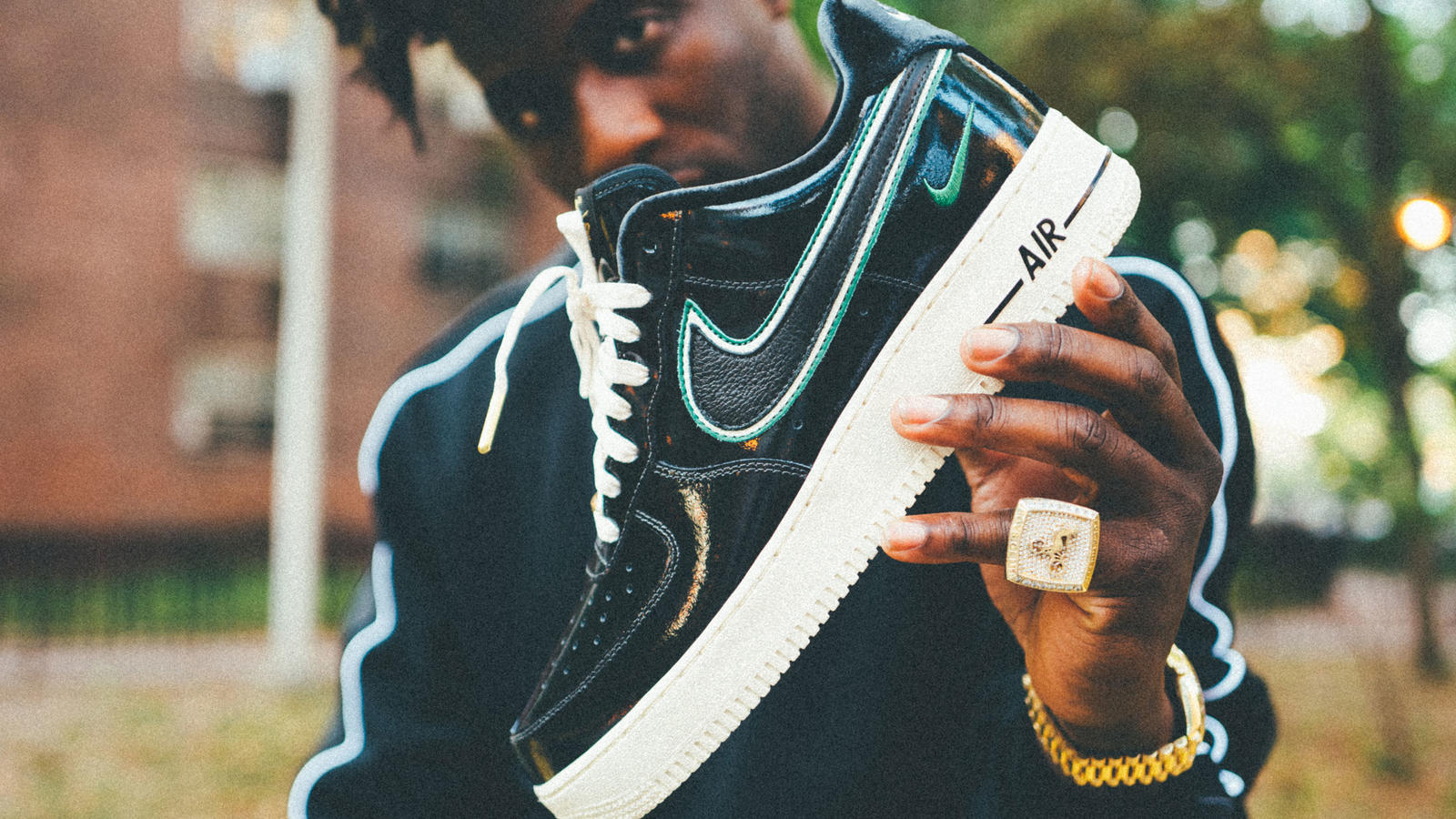 A man holding a Nike Air lifestyle shoe.