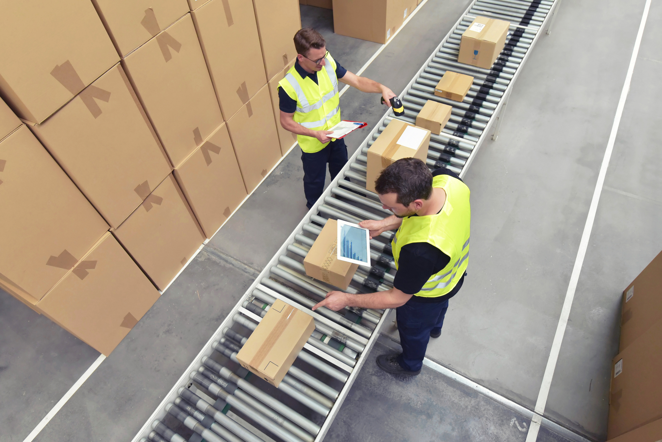 Workers using handheld scanners.