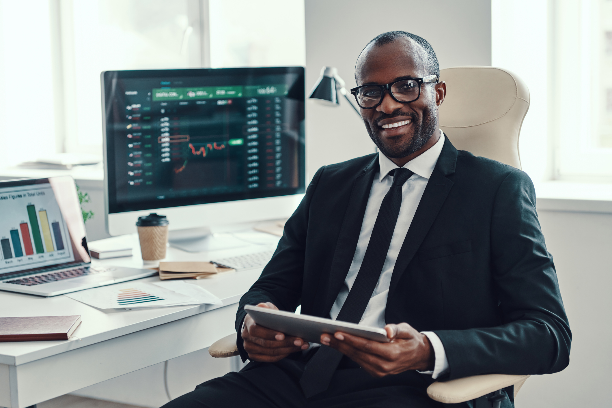 Businessman with a stock chart in the background.