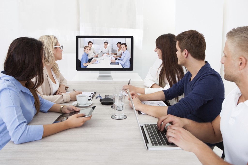 A Zoom conference call with five people in one room and five people in the other.
