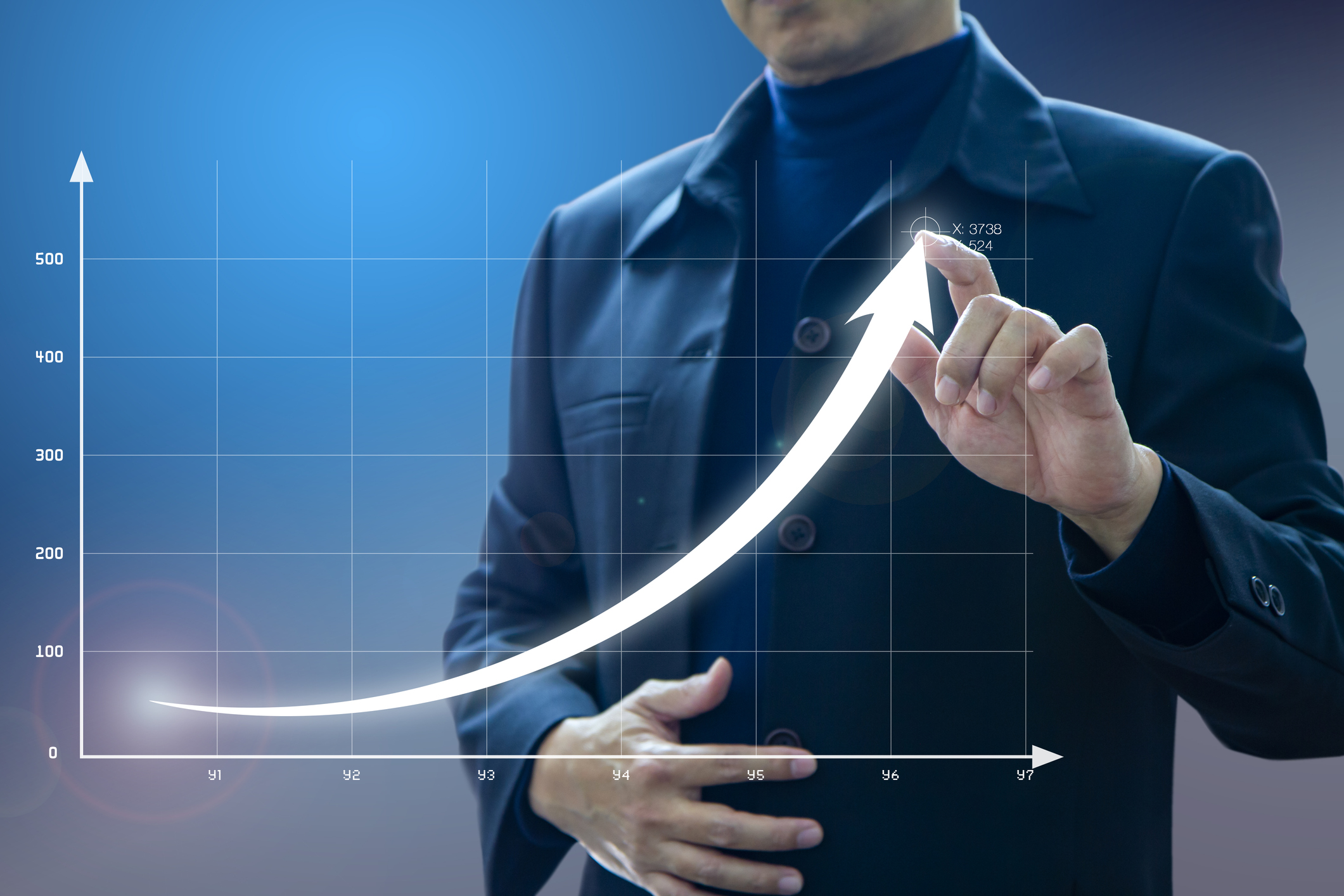 A businessman draws an exponential growth curve on a line graph.