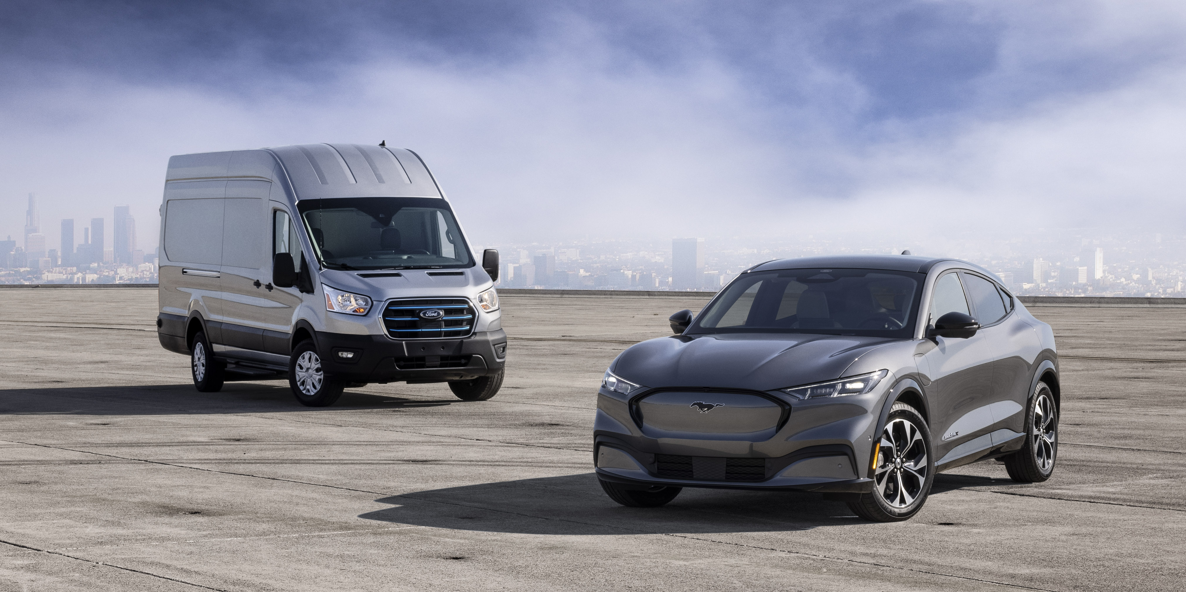A prototype of Ford's e-Transit, an electric commercial van, with a silver Ford Mustang Mach-E electric crossover.