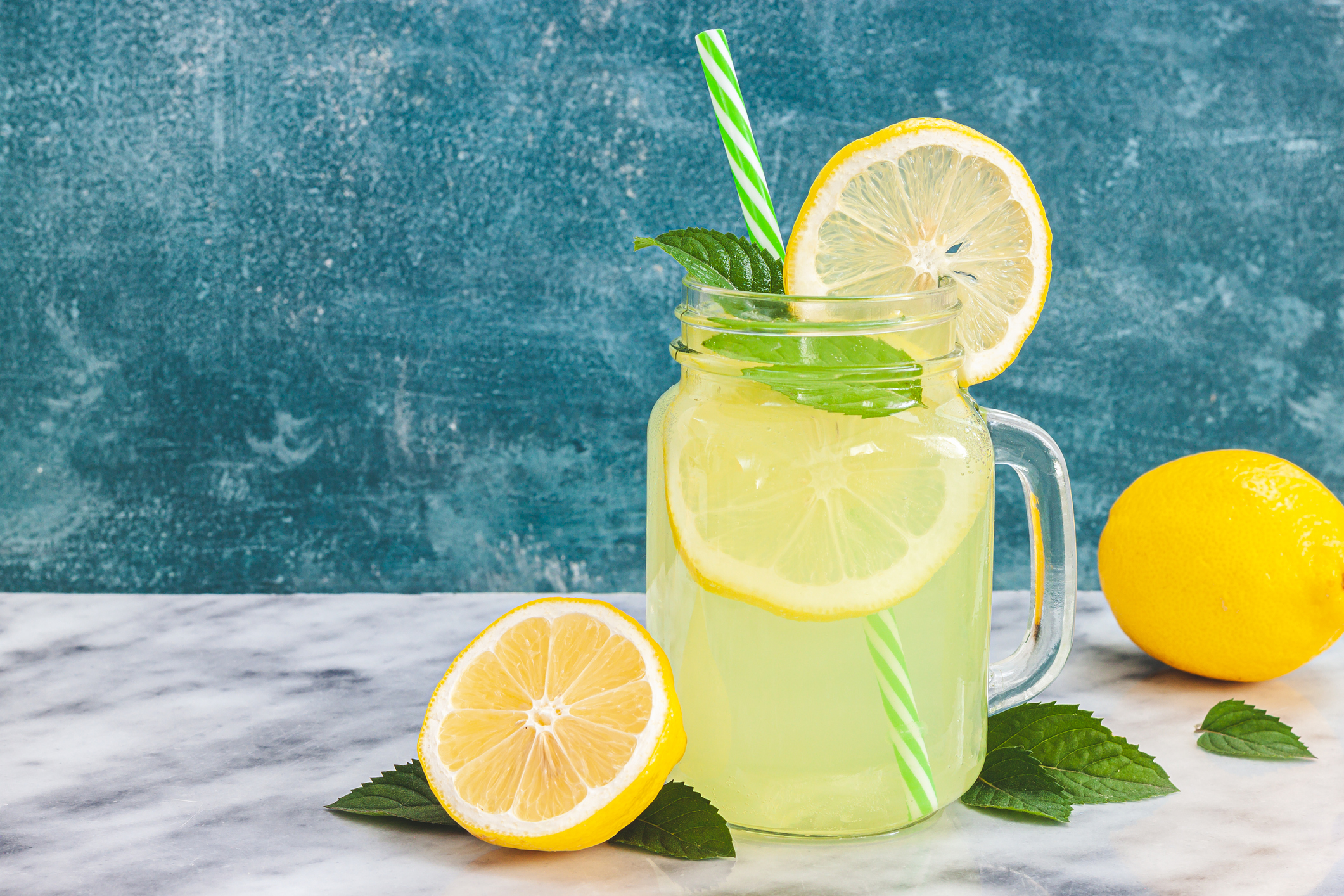 Jar of lemonade with a straw.