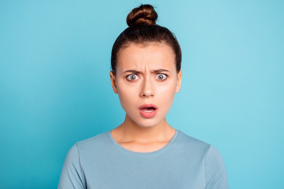 A shocked woman doesn't appear to believe something she's been told.