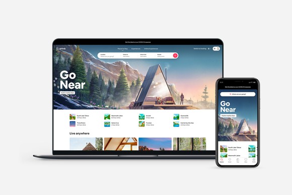 A computer and a smartphone display the Airbnb platform.