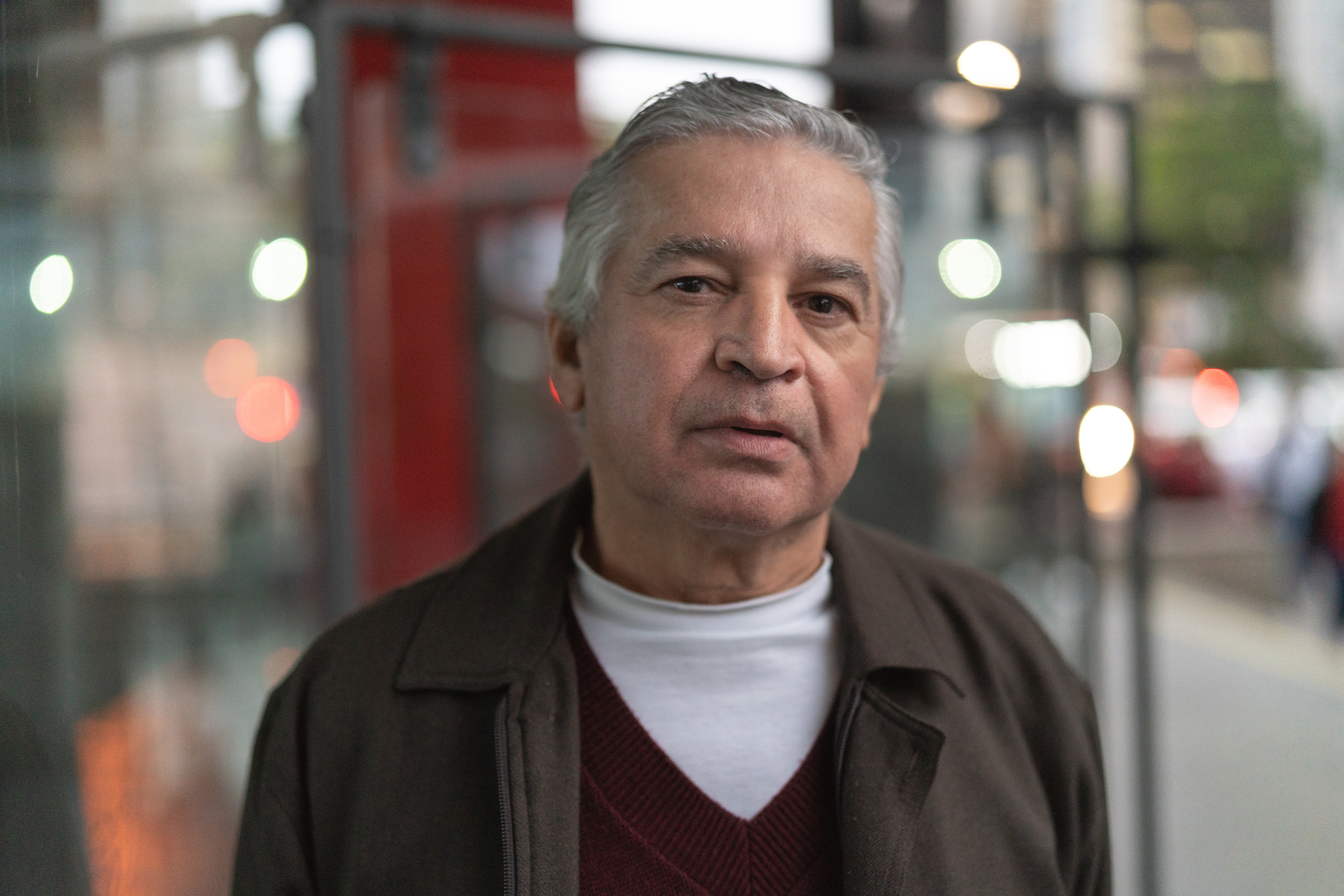 Older man with serious expression outdoors