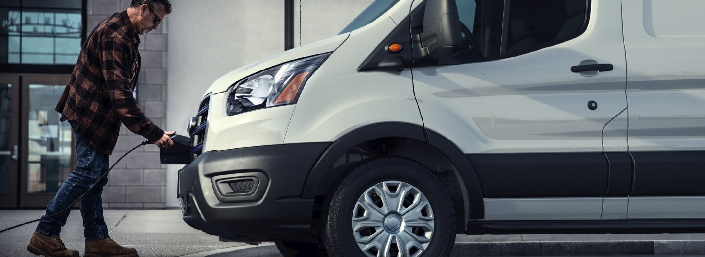 Man attaching a plug to a van