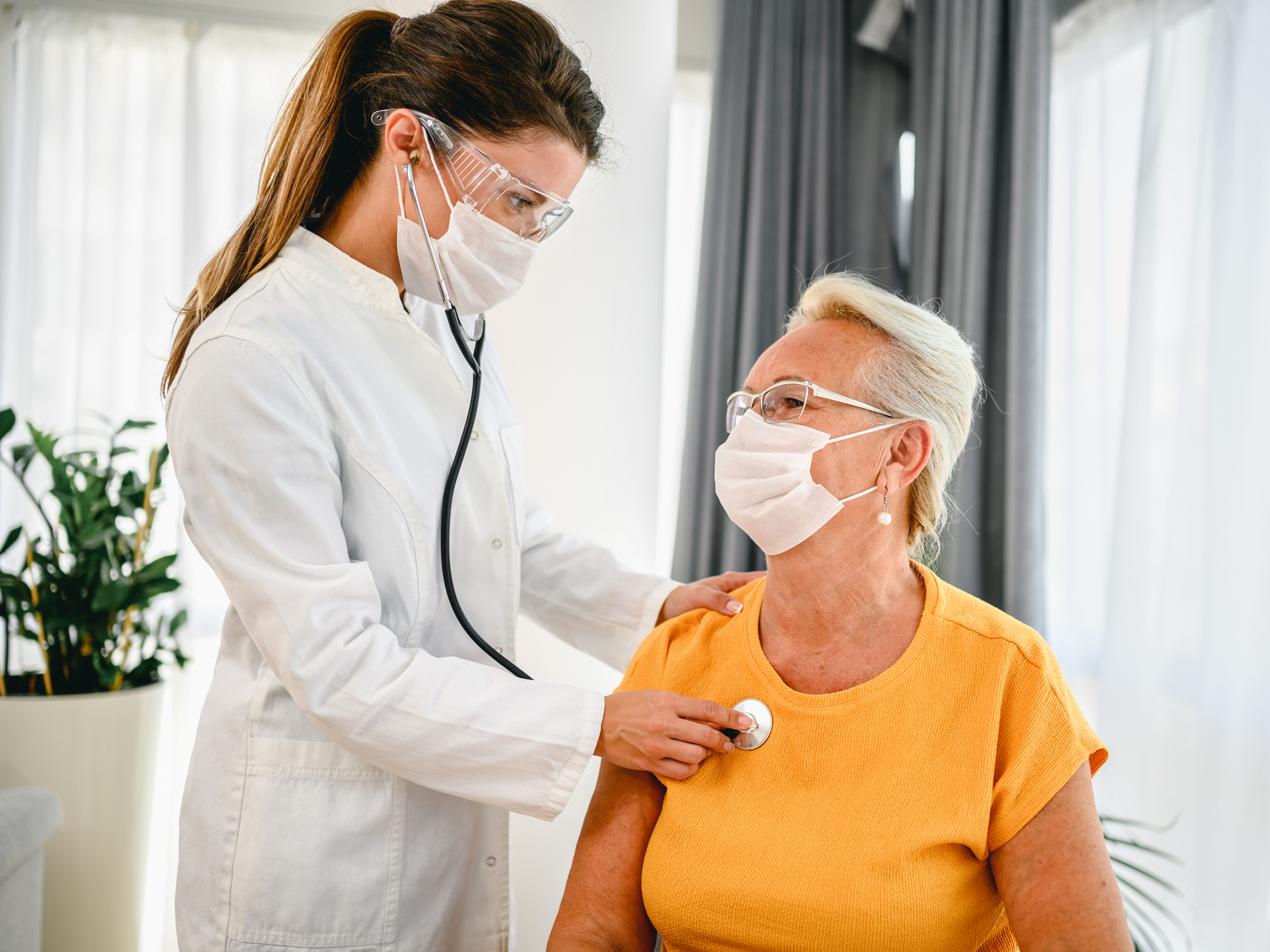 Doctor listening to a patient's chest with a stethoscope