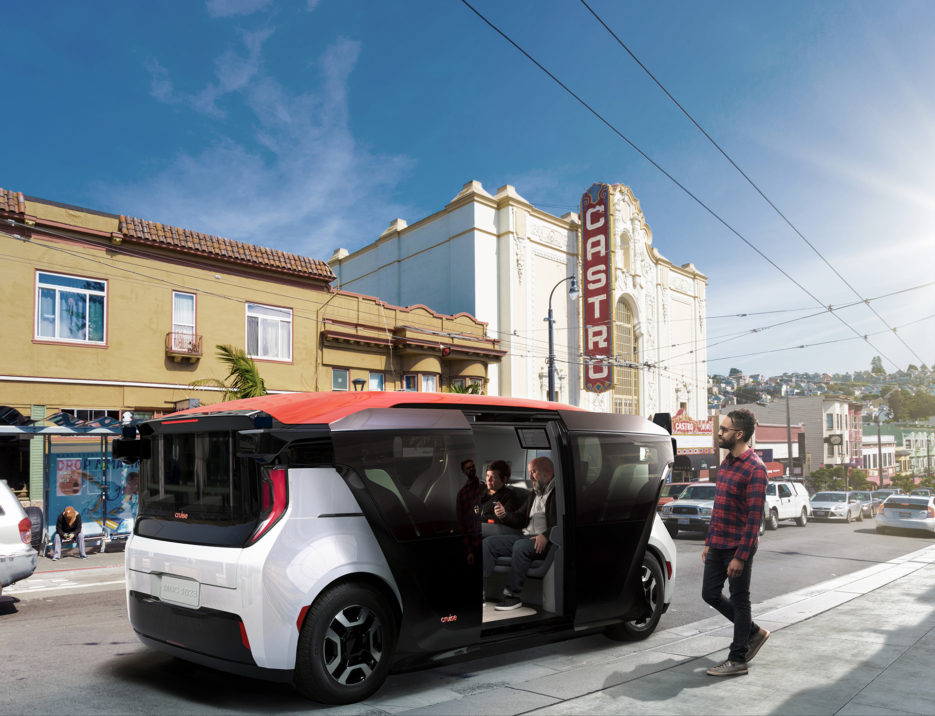 A Cruise Origin, a self-driving passenger van, is shown boarding passengers on a San Francisco street. 