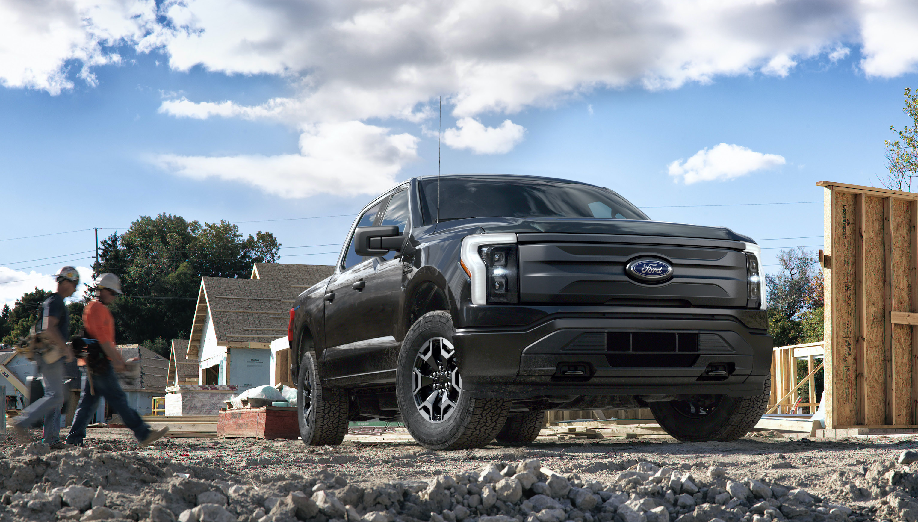 A Ford F-150 Lightning Pro, an electric pickup for commercial use, shown on a construction site.