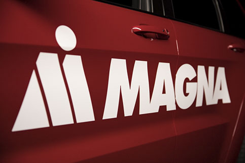 The Magna logo on a red vehicle's door.