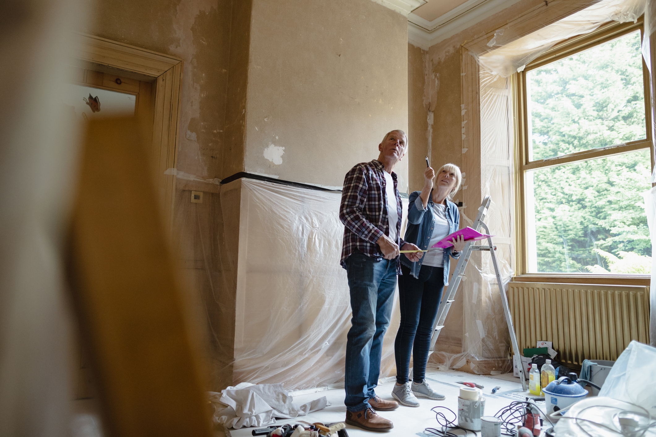 An older couple surveys the construction work in a room