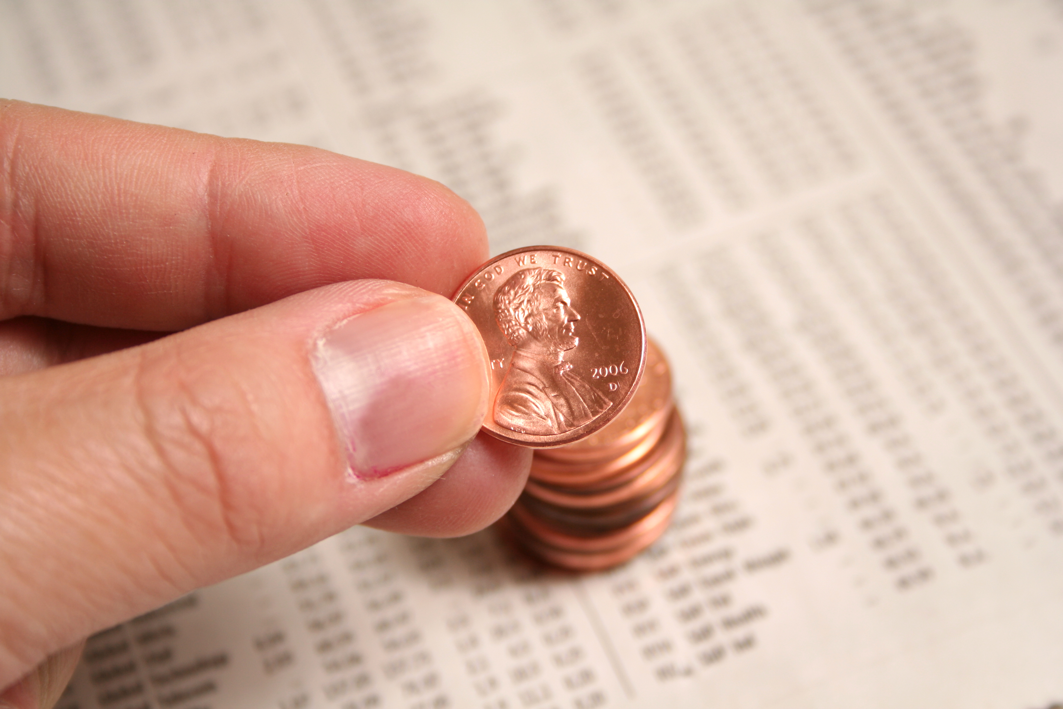 Pennies stacked on financial papers.