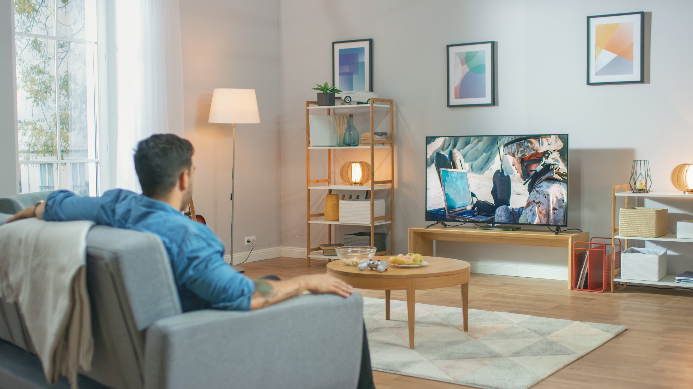 A man sitting on a couch watching TV.