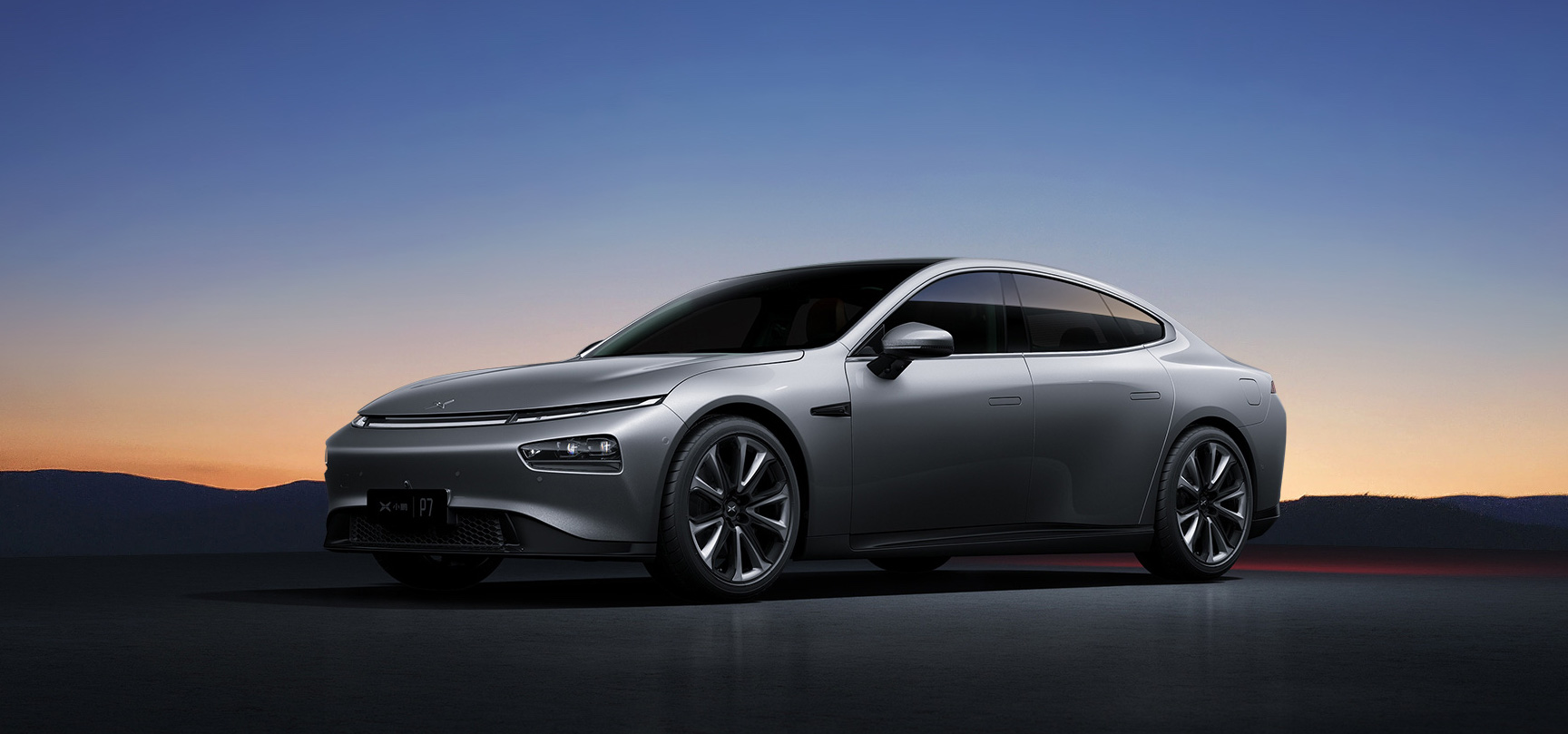A silver Xpeng P7, a sleek electric midsize sedan.