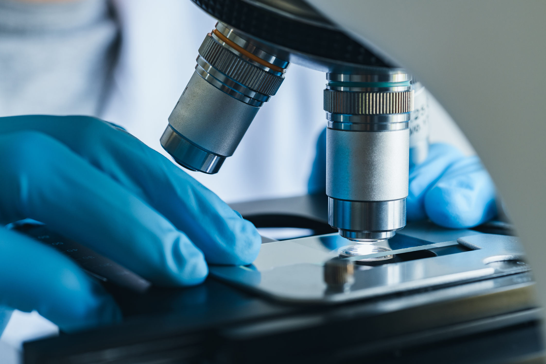 Medical professional using a microscope