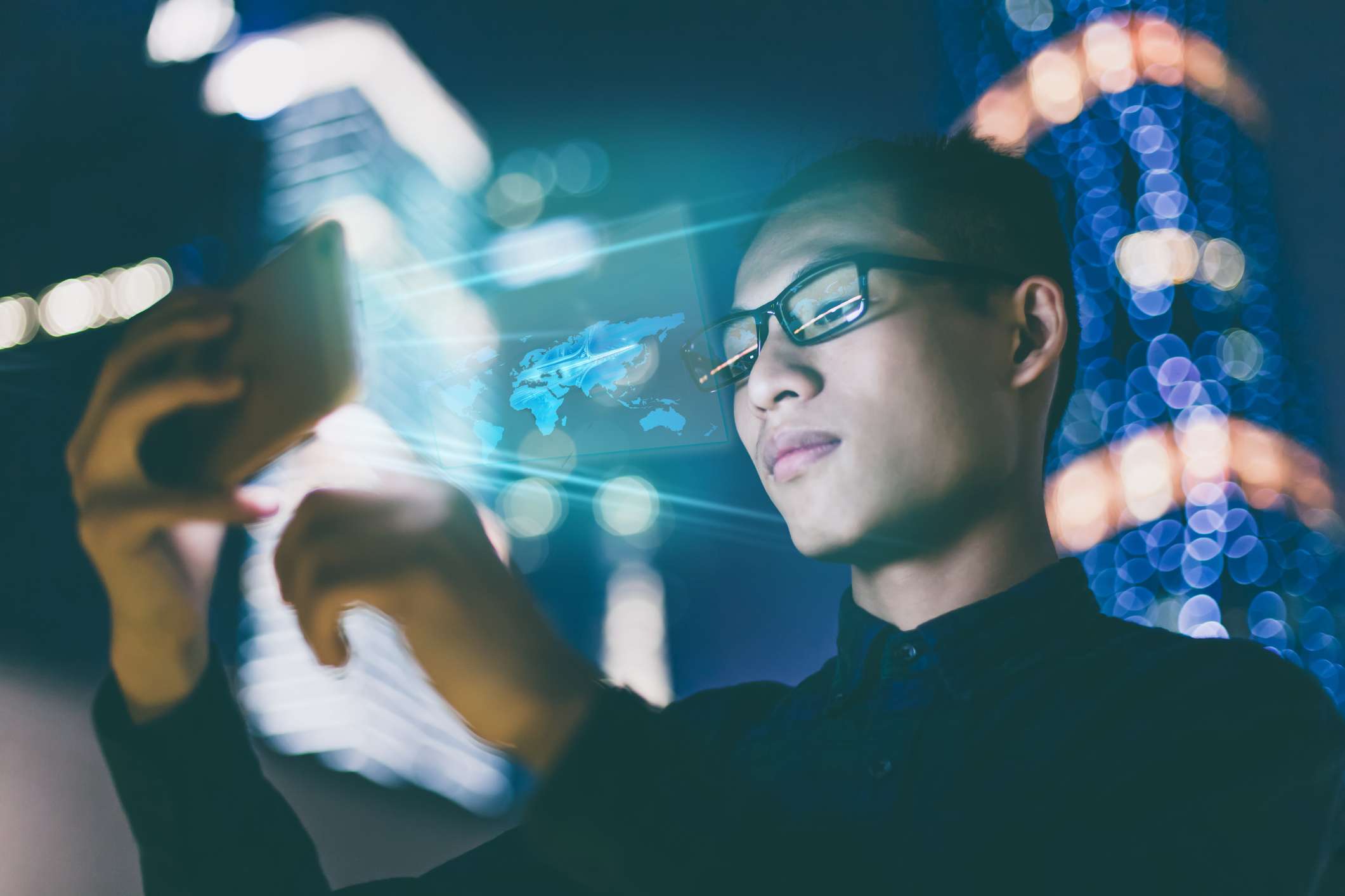 Man looking a cell phone and a map beams out towards his face.