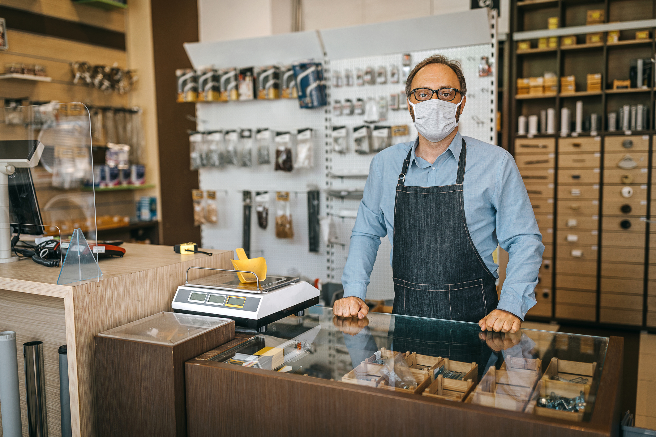 Man with mask standing in hardware store