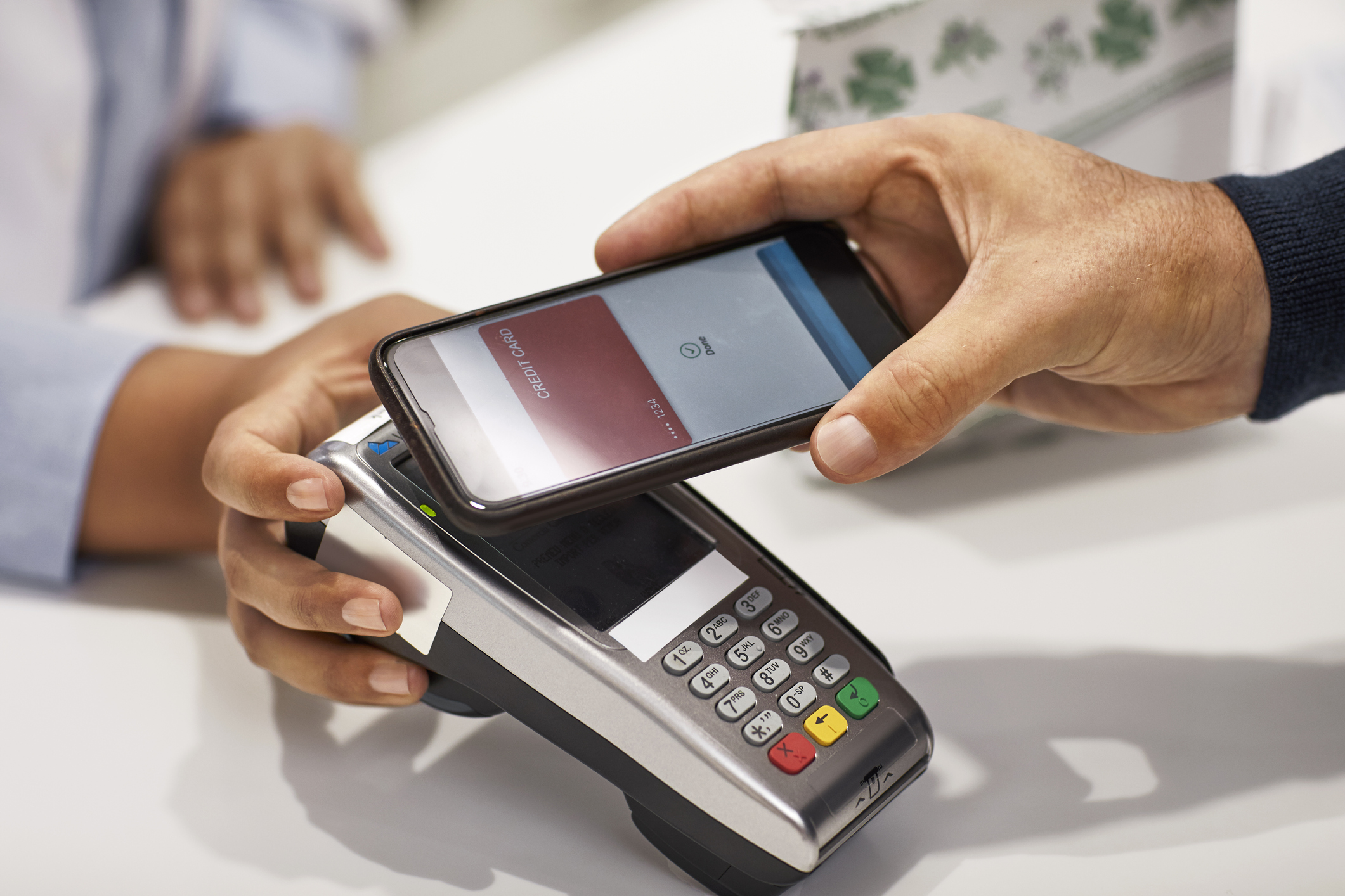 Someone paying with smartphone at register