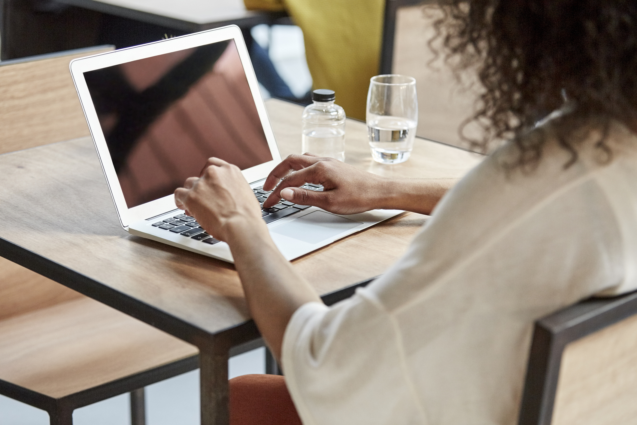 A woman using a laptop.
