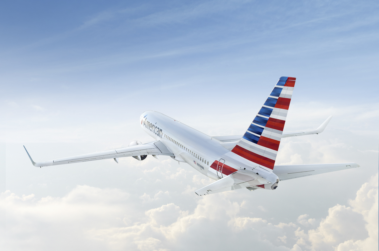 An American plane in flight over clouds.