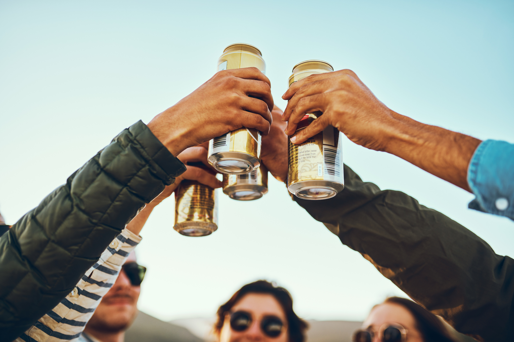 Friends drinking beer outside.