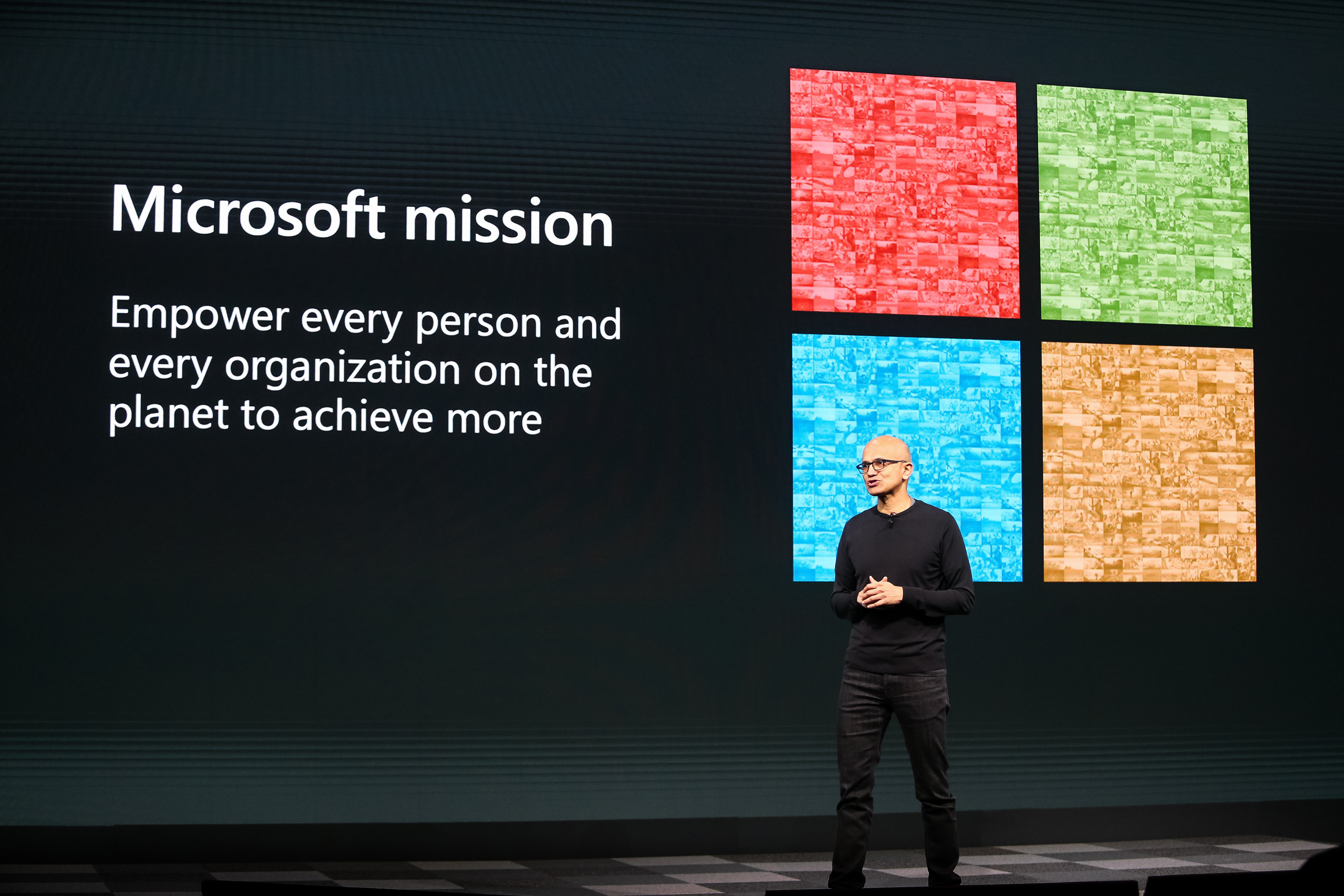 Satya Nadella standing on a stage giving a presentation