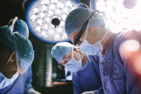 A surgeon wearing Vuzix's M300XL Smart Glasses in operating room.
