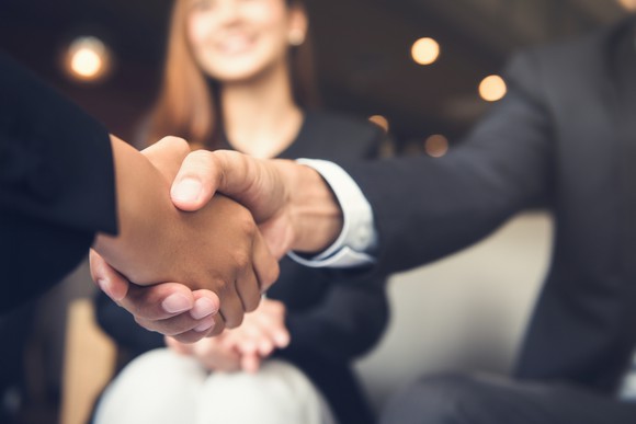 Two people shaking hands.