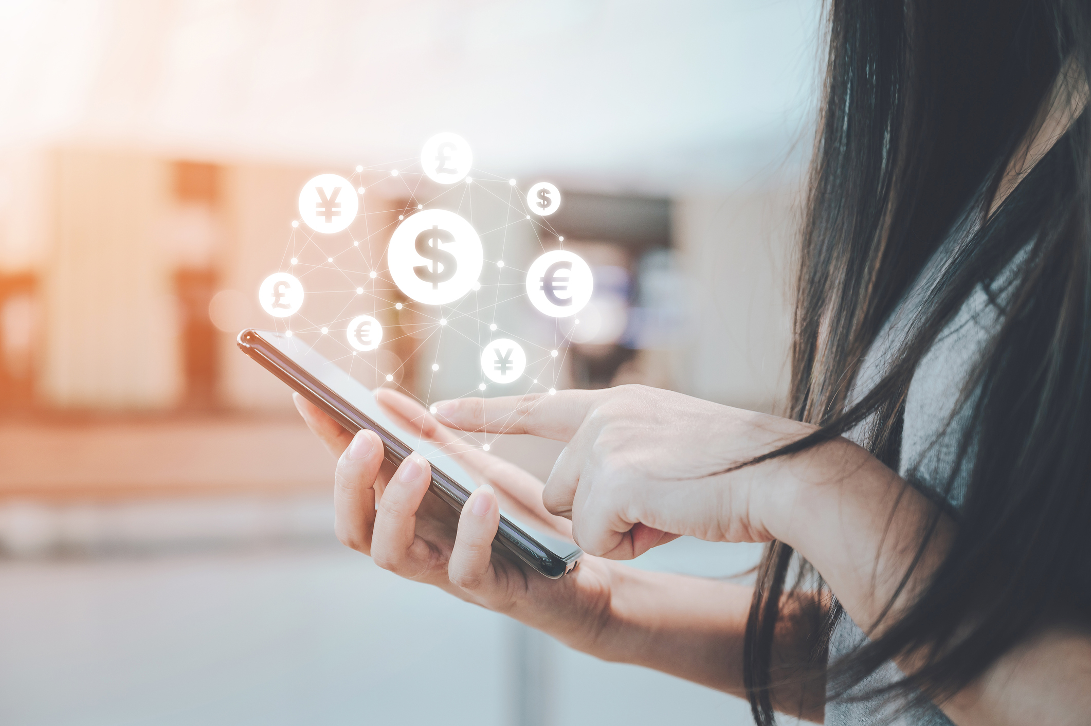 A woman uses a mobile payment app on her phone.