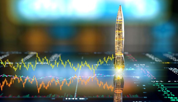 A digital stock chart leading to a rocket that's readying for launch. 