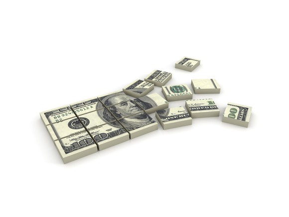 stack of $100 bills cut into squares representing sharing the wealth with dividends