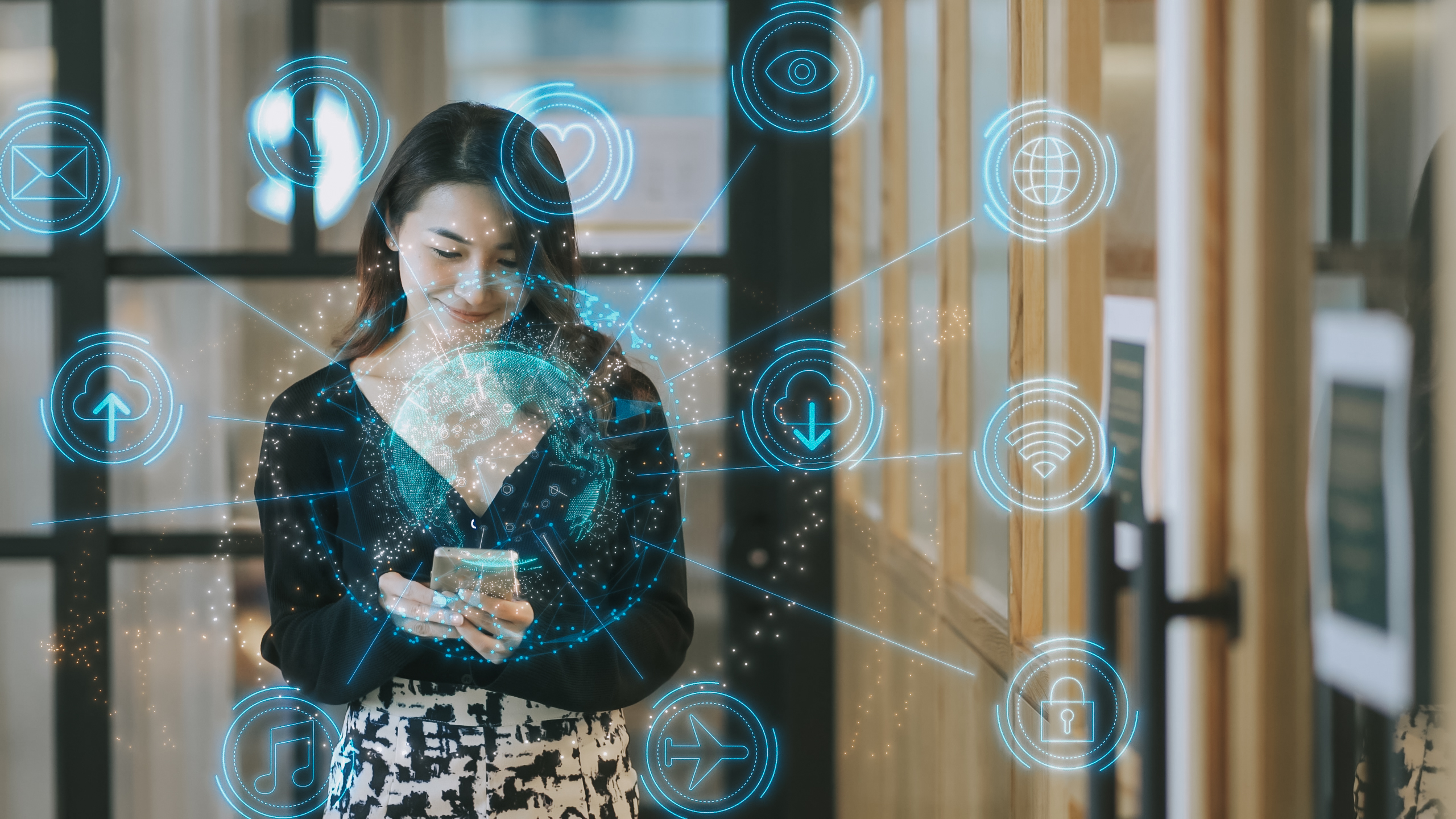 A young woman smiles and looks at her phone while light icons emerge from it.