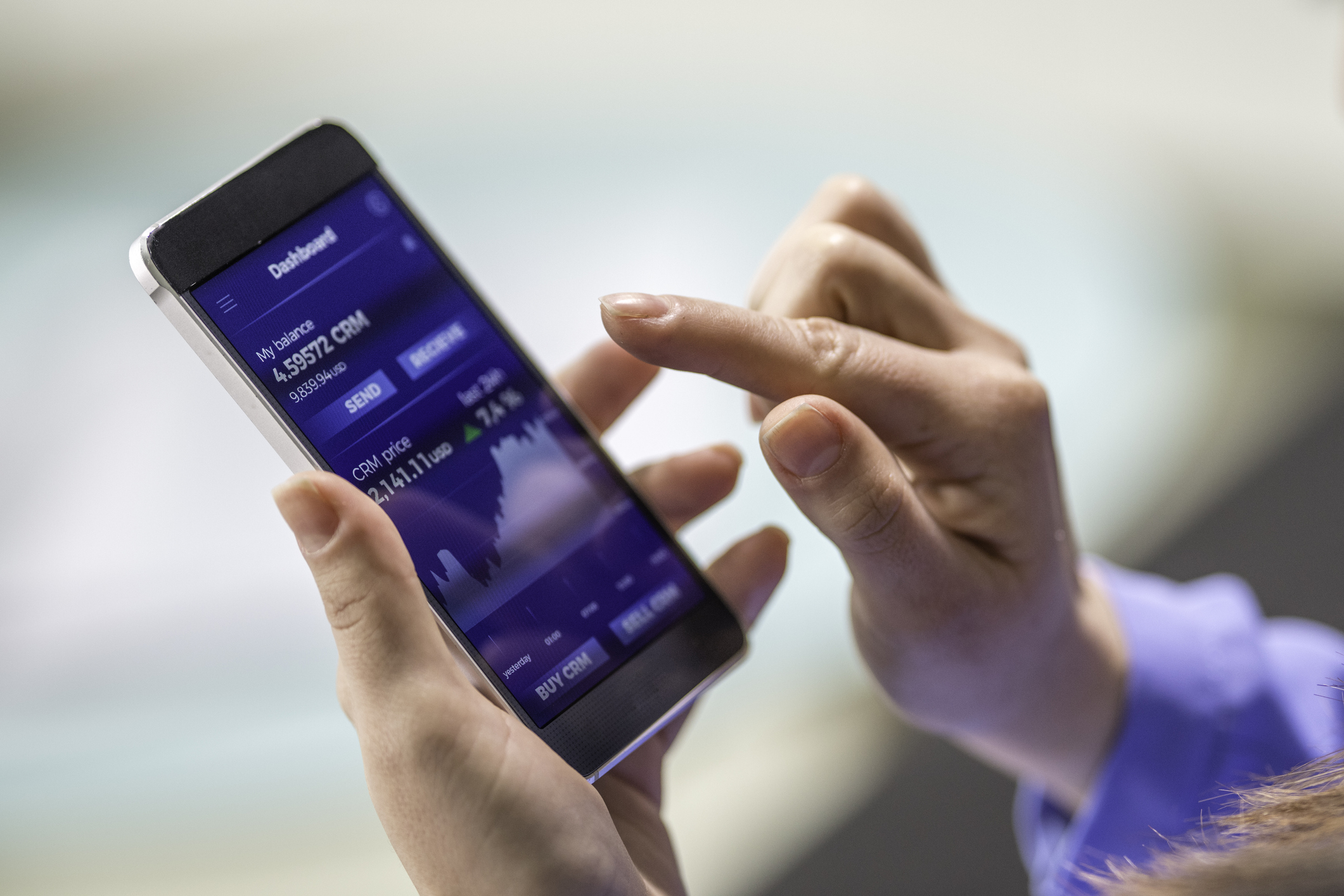 A woman trading stocks on her phone