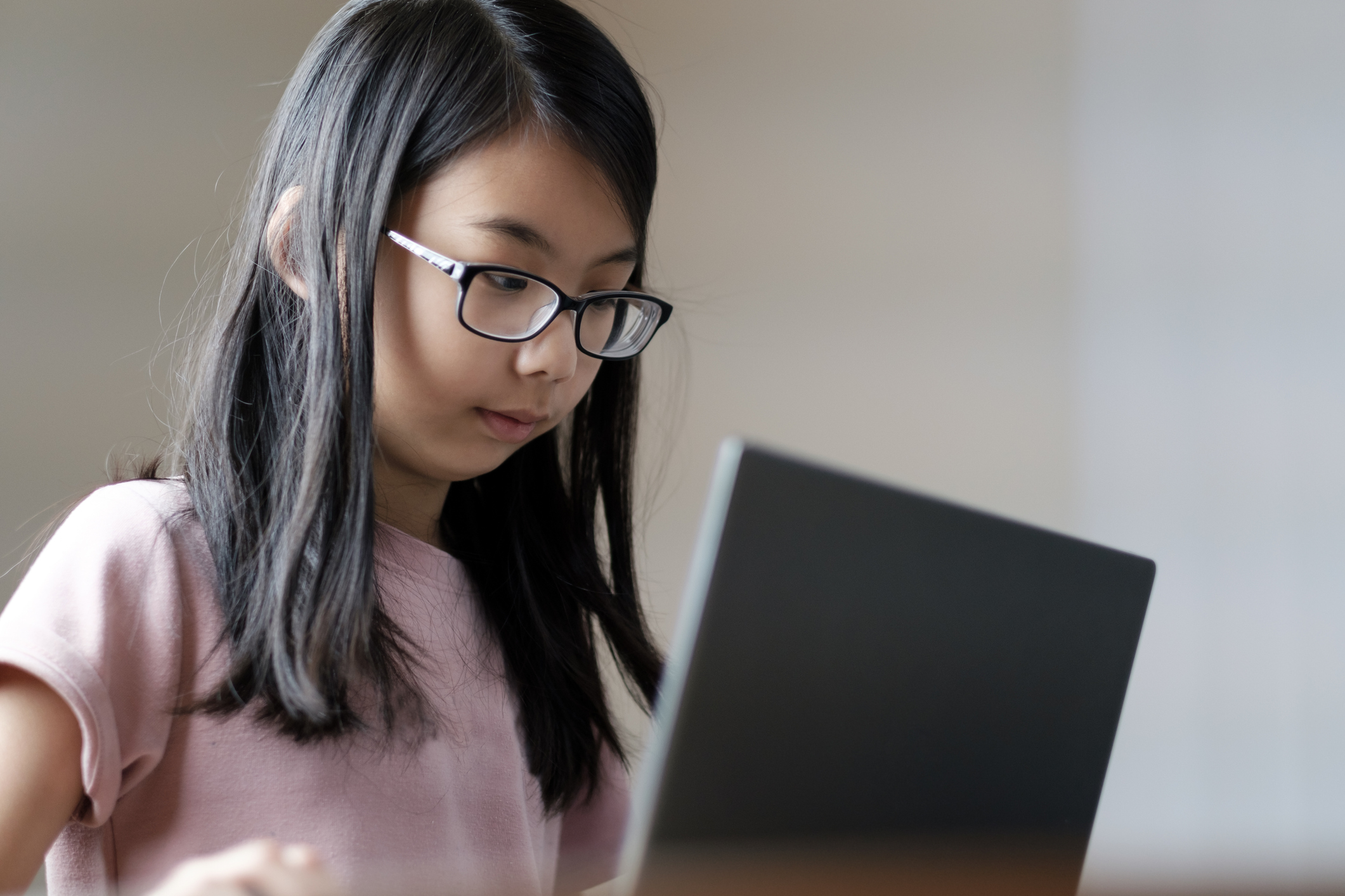 Girl looking at laptop screen.
