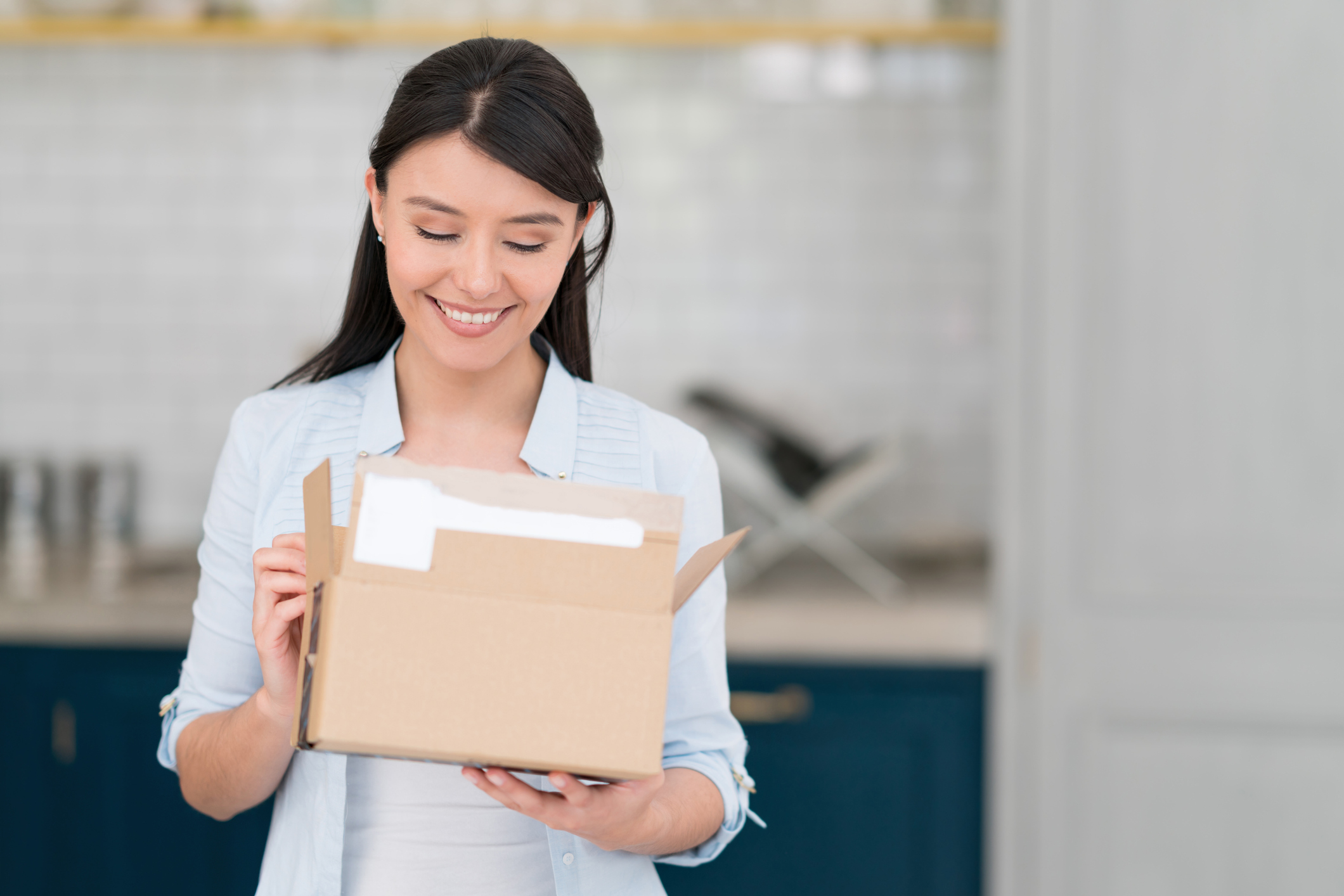A woman opening a package.