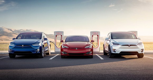 Tesla cars charging at a Supercharger station.