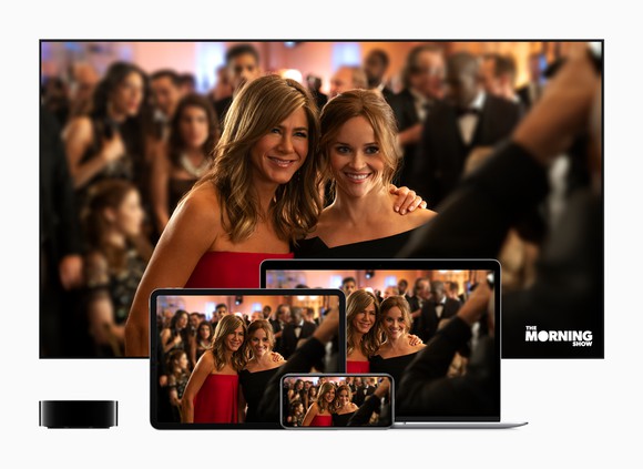Reese Witherspoon and Jennifer Anniston in a scene from the Apple TV+ original series The Morning Show shown on a connected TV, laptop, iPad and iPhone.