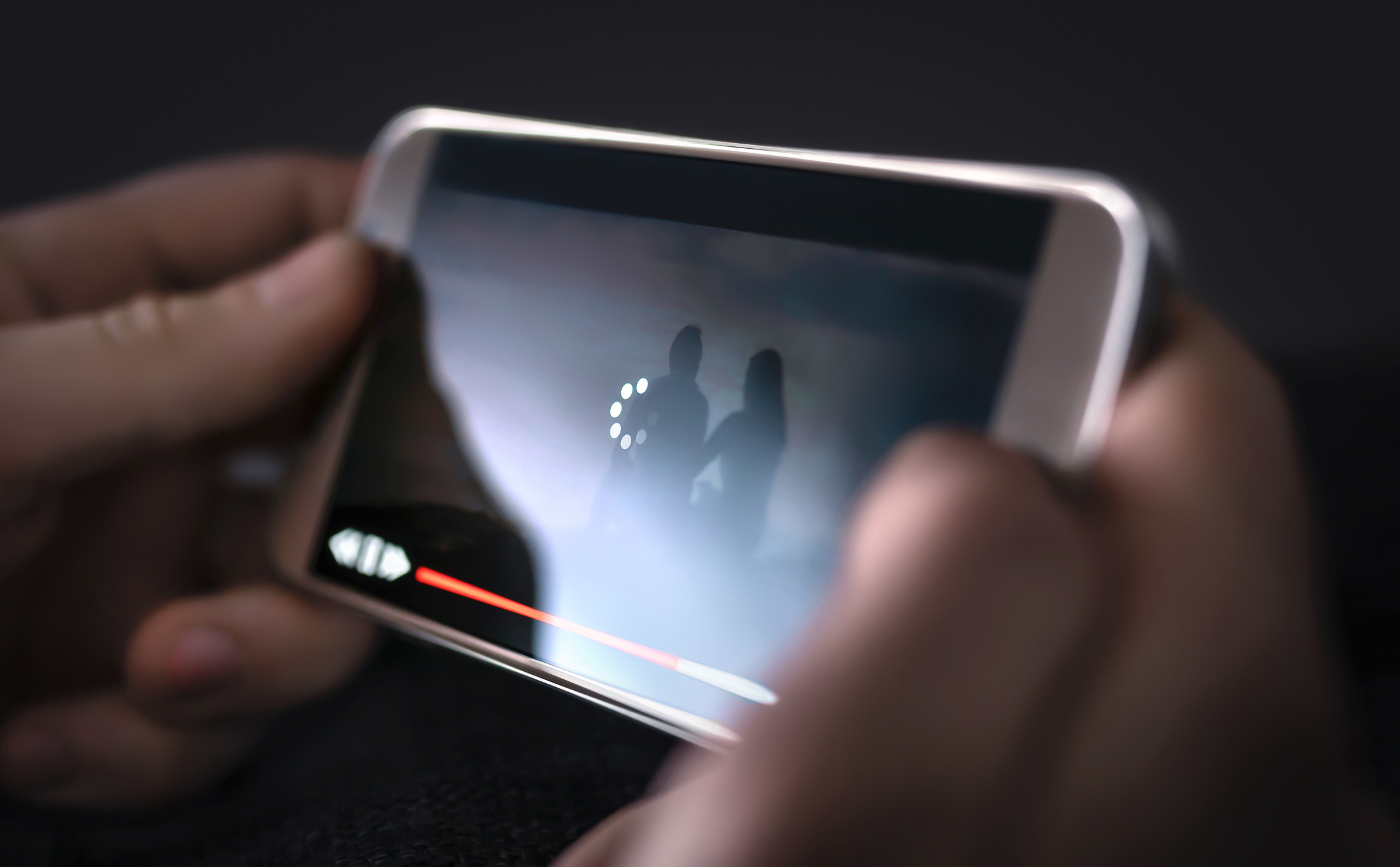 Person streaming video on a smartphone.