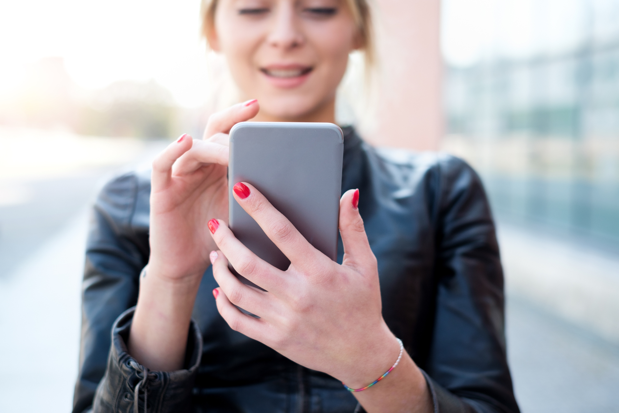 A woman uses a smartphone.