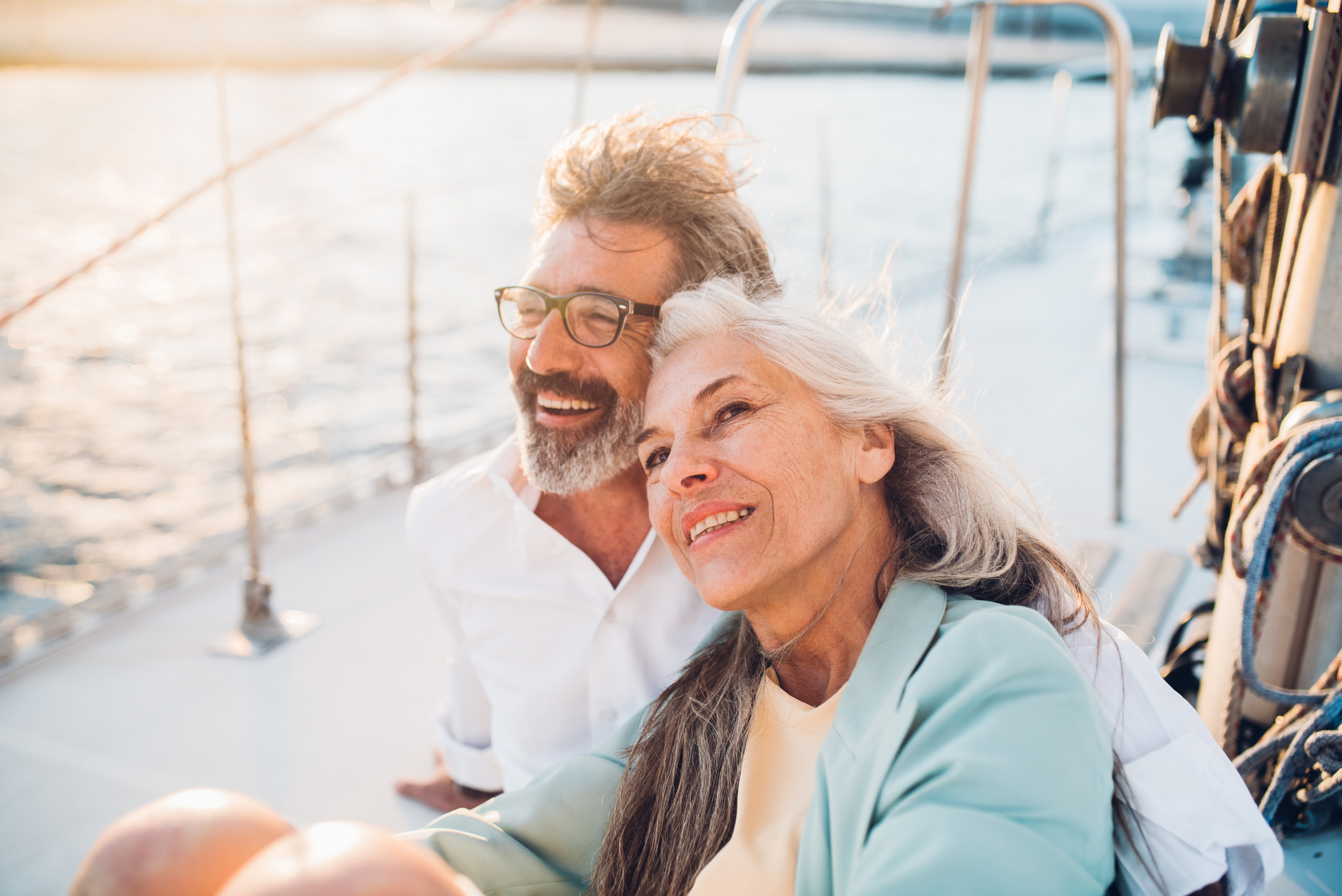 Mature man and woman sitting on a boat smiling